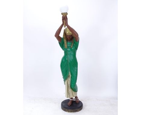 A painted composite study of an Egyptian figure holding a lamp, H181cm 