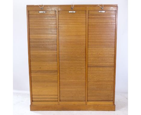 An early 20th century light oak-framed triple tambour-front filing cabinet, W122cm, H150cm, D38cm 