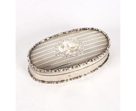An oval silver box, Chester 1906, the engine-turned lid with central cartouche, 12cm wide, approximately 140gm 