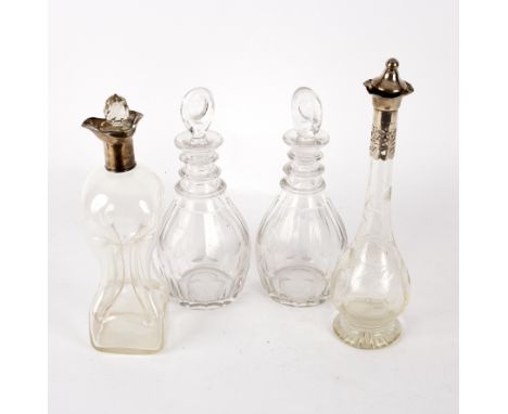A silver mounted hourglass shaped decanter, Nathan &amp; Hayes, Chester 1906, another silver mounted decanter and a pair of t