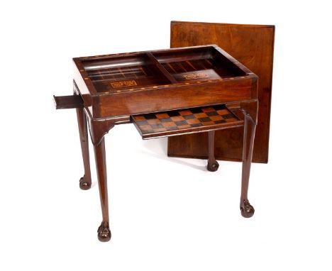 An 18th Century Irish mahogany silver/games table, the dished top enclosing an interior inlaid for backgammon, on taper legs 