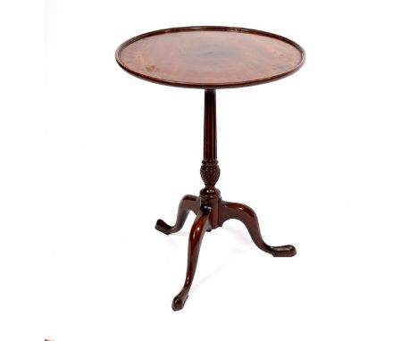 A George III mahogany wine table, the circular top with raised lip to the border on a fluted column and tripod base, 50cm dia