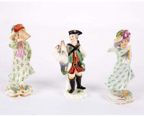 A miniature Meissen figure of a gentleman with game, 20th Century, 8cm high and a pair of Meissen miniature figures of winged