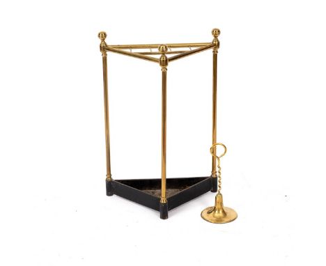 A brass corner stick stand, with cast iron base, 42cm wide and a brass door porter (2) CONDITION REPORT: Lot 692 Triangular b