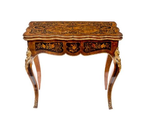 A 19th Century marquetry and gilt metal mounted card table, the fold-over top inlaid musical instruments, birds and scrolls i