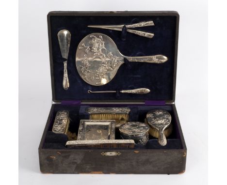 A Chinese silver coloured metal dressing set of eleven pieces, stamped Tuck Chang, cased and a travelling clock somewhat simi