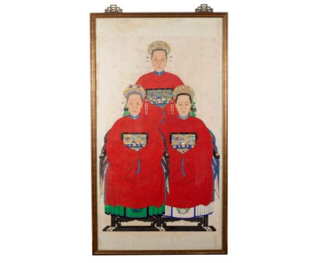 A Qing Chinese ancestor portrait of a gentleman, his wife and daughter, wearing red Mandarin jackets, watercolour on linen, n