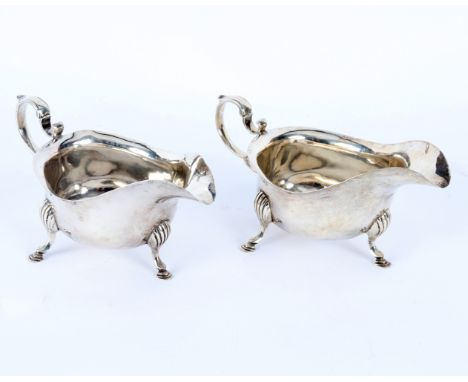 A pair of Georgian style silver sauce boats, Birmingham 1910, with double scroll handle and tripod legs, 9cm x 18cm, approxim