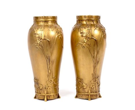A pair of Art Nouveau bronze vases by Marioton, each of baluster shape decorated in low relief with daffodils and other flowe