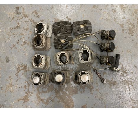 A selection of Kawasaki engine componentsbelieved three-cylinder type, including eight cylinder barrels, three cylinder heads