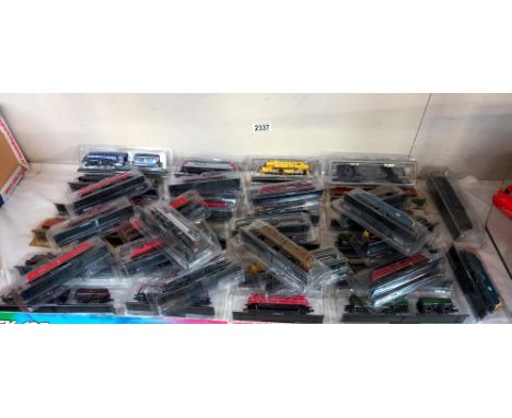 A quantity of unpowered 'N' Gauge model trains in packaging 
