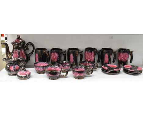 VALLAURIS; a part tea service decorated in pink lustre, comprising teapot, milk jug, six mugs, five teacups and six saucers. 