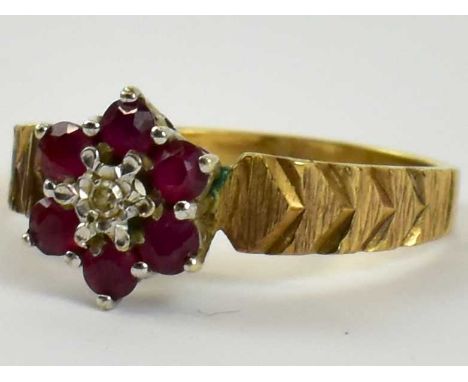 A 9ct yellow gold ruby and diamond flower head ring set with small central diamond surrounded by six small rubies, size P, ap