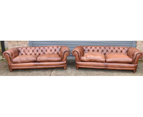 A pair of modern brown leather button upholstered Chesterfield three seated settees, width approx 210cm. 