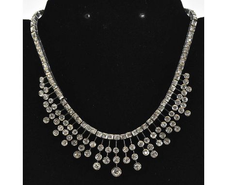 A white metal Art Deco style frilled diamond set necklace, the largest stone approx 0.5ct, diamonds totalling approx 8ct, len