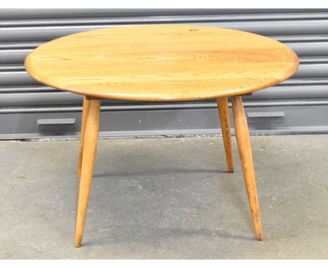 A mid century light oak oval coffee table, diameter 75cm.
