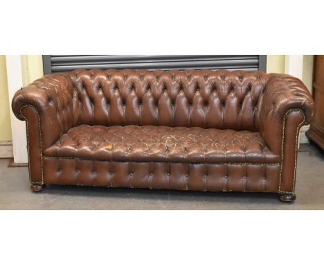 A brown button upholstered leather Chesterfield sofa, width 200cm.