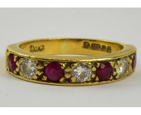 An 18ct yellow gold diamond and ruby half eternity ring set with four small rubies and three small diamonds, size K/L, approx