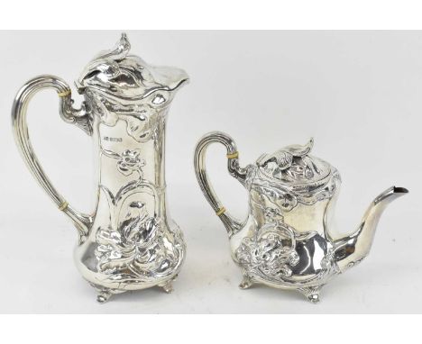 X HENRY ATKIN; a George V hallmarked silver teapot with floral decoration, height 14cm, together with matching floral decorat