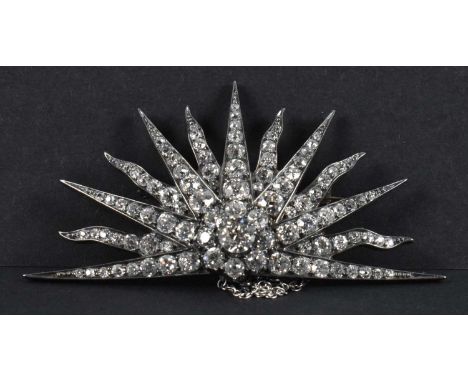 A 1930s Art Deco white metal diamond set sunburst brooch, the central stone weighing approx 0.75ct and diamonds totalling app