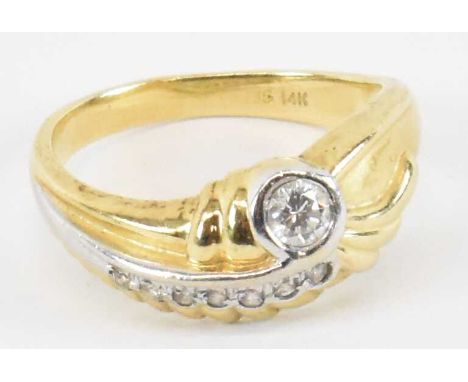 A 14ct yellow gold ring set with central diamond and seven small stones, size L/M, approx 4.3g. 