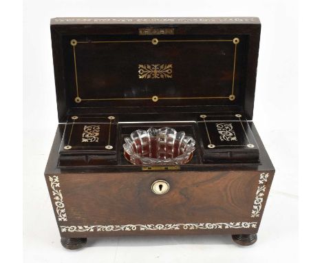 A 19th century rosewood and mother of pearl inlaid sarcophagus form tea caddy on bun feet, with fitted mother of pearl inlaid