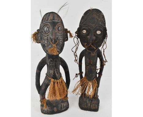 A pair of African ancestoral figures, male and female, height 38cm. 