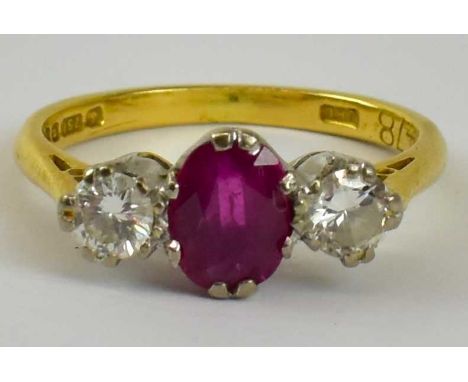 An 18ct yellow gold three stone ruby and diamond ring set with central ruby between two diamonds, size K, approx 3g.