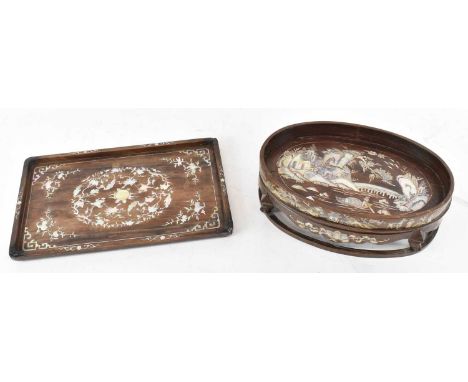 A Chinese carved hardwood and mother of pearl inlaid oval footed dish, decorated with scenes depicting figures and pagodas am