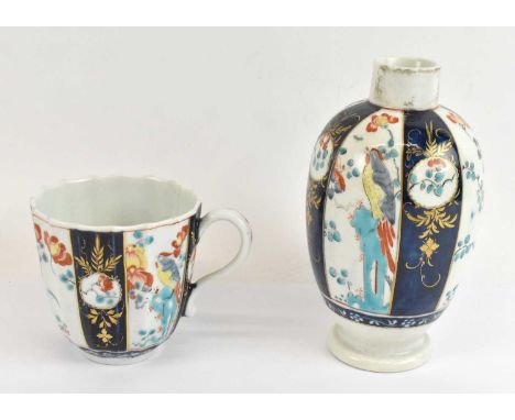 WORCESTER; a first period Worcester tea caddy, lacking cover, height 13cm and matching cup, decorated in the 'Sir Joshua Reyn