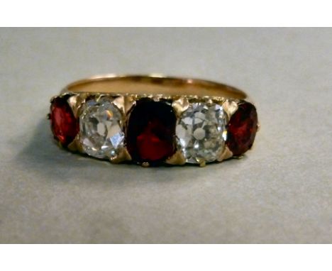 A yellow metal ring, set with three alternating rubies and two diamonds   