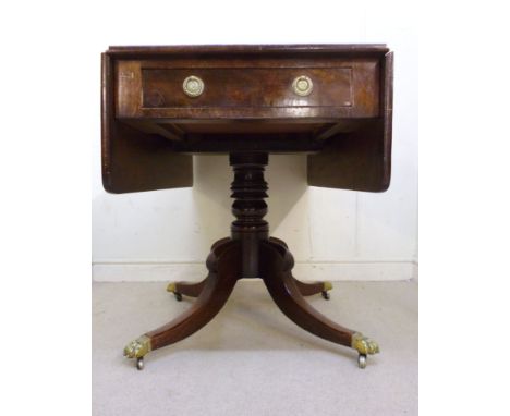 A Regency mahogany Pembroke table, the top having round corners, over an end drawer with cast brass ring handles and an ebony