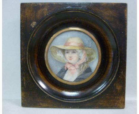 Early 20thC British School - a circular head and shoulders portrait miniature, a young woman wearing a broad brimmed hat with
