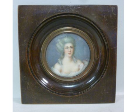 ED - a circular head and shoulders portrait miniature, a scantily clad woman with long grey hair  bears initials in a glazed 