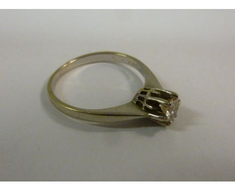 A white metal diamond solitaire ring with a brilliant cut claw set stone