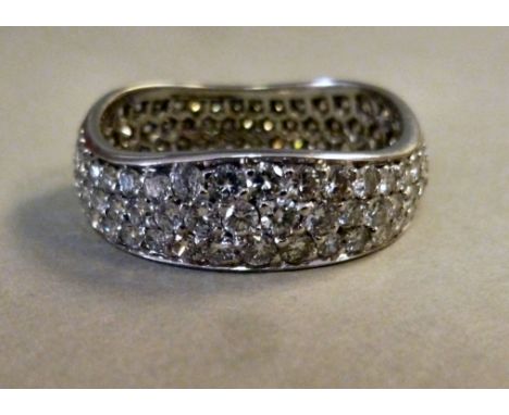 A Cartier white metal band design ring, set with three rows of diamonds  
