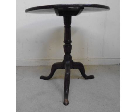 A late 18th/early 19thC mahogany pedestal table, the tip-top having a round edge, over a ring turned, vase column, raised on 