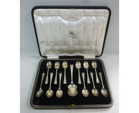 A set of twelve silver Art Deco inspired coffee spoons; and a matching caddy spoon  Cooper Brothers  Sheffield 1935  cased