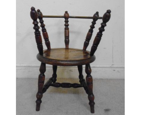 A late 19thC mahogany Windsor chair, having a tubular brass, curved back rail, ring turned supports and a moulded solid seat,