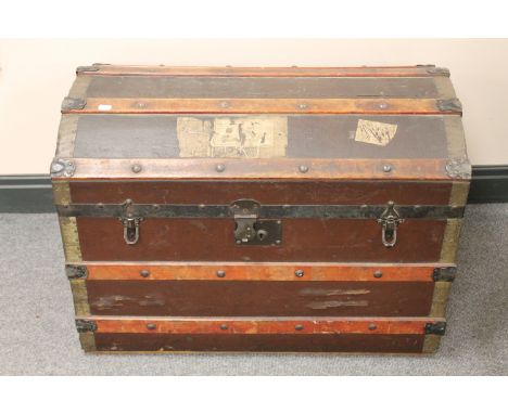 An early 20th century domed topped shipping trunk  
