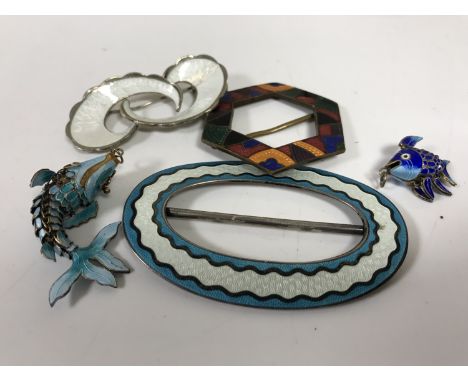 A Norwegian silver and enamel brooch, an enamelled silver buckle, another buckle and two enamelled fish pendants