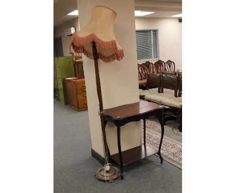 An Edwardian mahogany two tier table together with a standard lamp with shade