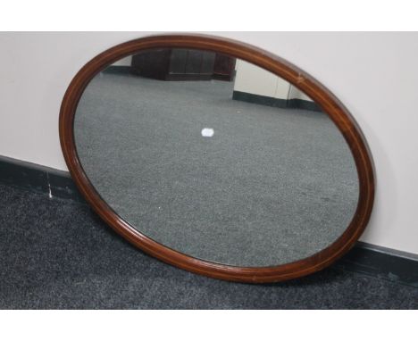 An inlaid mahogany Victorian oval framed mirror 