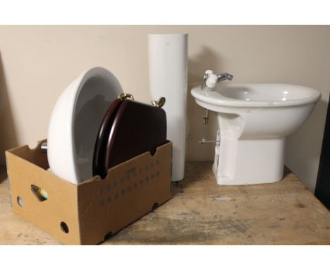 A sink and pedestal together with a bidet, set of basin taps etc