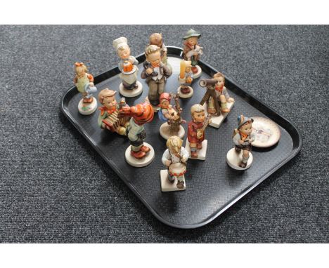 A tray of thirteen West German Hummel figures (a/f), together with a Hummel plate 