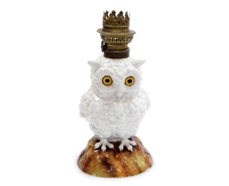 A late 19thC Continental porcelain table lamp, modelled as an owl, in standing pose on a naturalistic base, 25cm high.