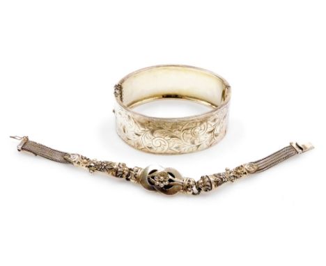 A George V silver bangle, with engraved foliate decoration, on snap clasp with safety chain as fitted, Birmingham 1934, toget
