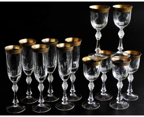 A set of six Bohemian cut glass champagne flutes, each with a gold coloured rim, and gilt highlight to foot, together with si