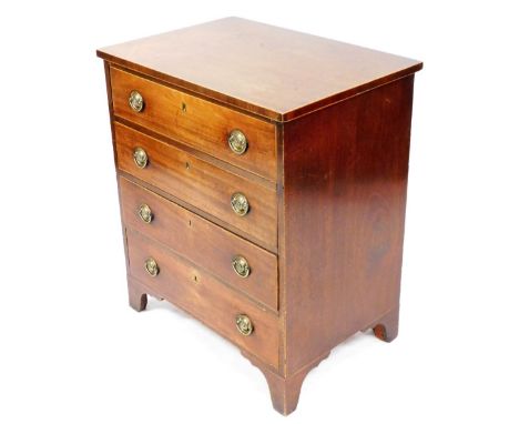 An early 19thC mahogany and boxwood strung small chest of four drawers, with brass drop handles and bracket feet, later conve