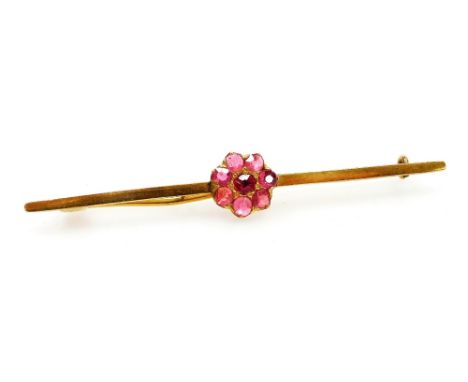 A ruby seven stone flower head bar brooch, in yellow metal, unmarked, possibly Burmese rubies, 4.5g. 